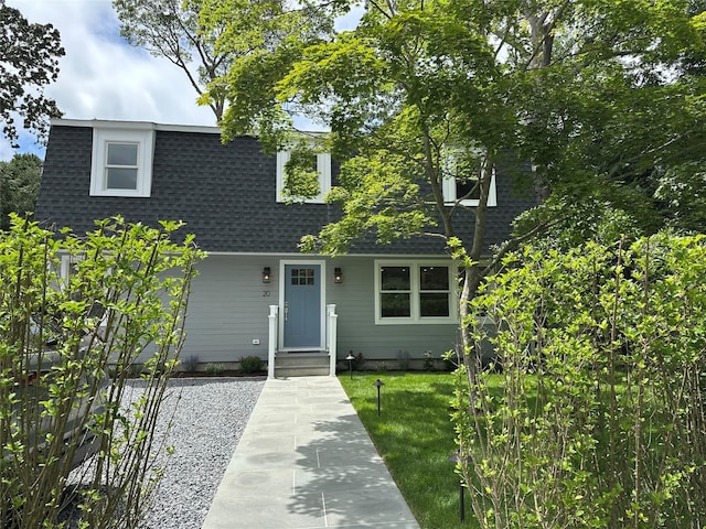 20 Oak Grove Rd, Southampton, NY 11968 - view of front of home with a shingled roof and a front yard