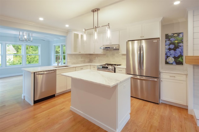 20 Oak Grove Rd, Southampton, NY 11968 - kitchen with stainless steel appliances, crown molding, light wood finished floors, tasteful backsplash, and white cabinets