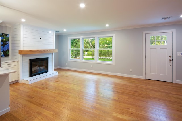 20 Oak Grove Rd, Southampton, NY 11968 - unfurnished living room featuring ornamental molding, a large fireplace, light wood-style floors, and recessed lighting