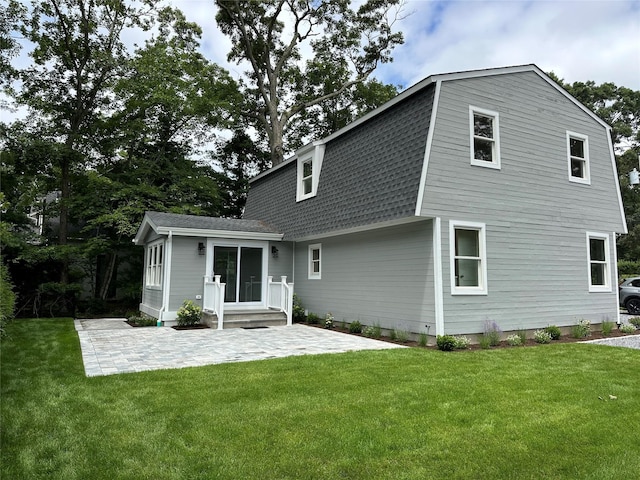 20 Oak Grove Rd, Southampton, NY 11968 - rear view of property with a gambrel roof, a patio, roof with shingles, and a yard