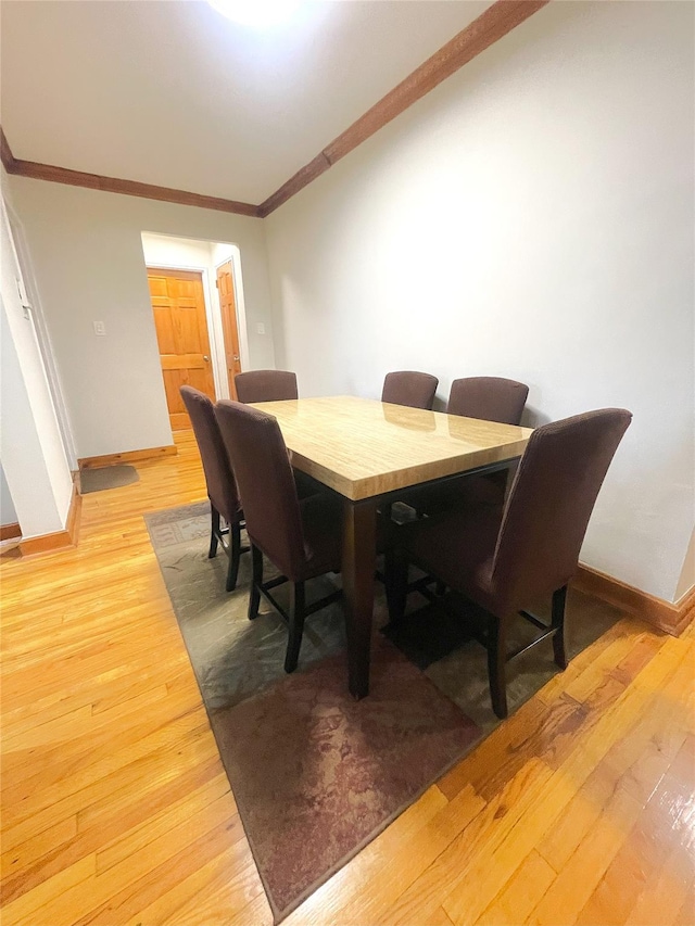 84-31 Van Wyck Expy Unit 5F, Briarwood, NY 11435 - dining room featuring light wood finished floors and crown molding