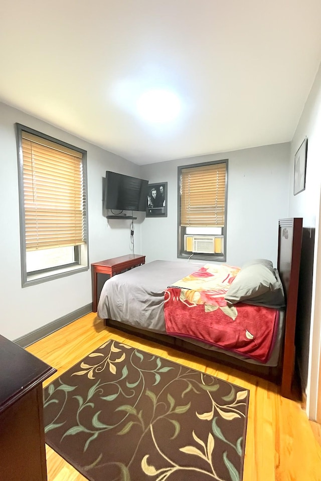 84-31 Van Wyck Expy Unit 5F, Briarwood, NY 11435 - bedroom featuring wood finished floors and cooling unit