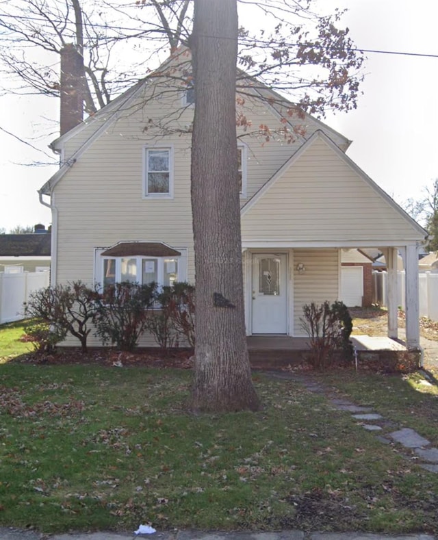 65 Mount Joy Ave, Freeport, NY 11520 - view of front facade with a chimney and covered porch