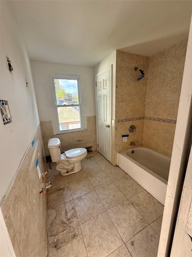 65 Mount Joy Ave, Freeport, NY 11520 - bathroom with tile walls, wainscoting, washtub / shower combination, and tile patterned floors
