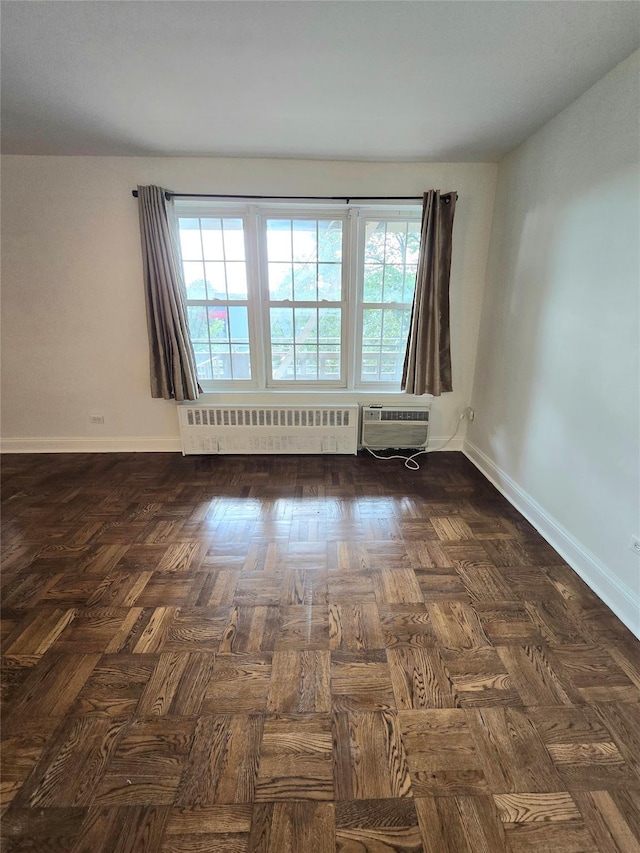 151-35 84th St Unit 1C, Howard Beach, NY 11414 - empty room with radiator, a wall mounted AC, and healthy amount of natural light
