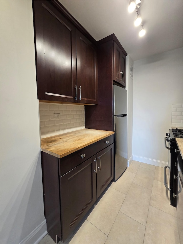 151-35 84th St Unit 1C, Howard Beach, NY 11414 - kitchen featuring freestanding refrigerator, black gas range, backsplash, wood counters, and dark brown cabinetry