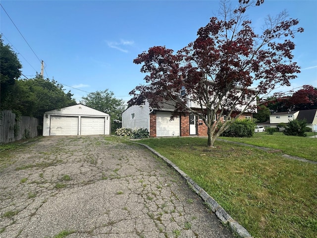 63 Grape Ln, Hicksville, NY 11801 - view of side of home featuring a detached garage, brick siding, and an outbuilding