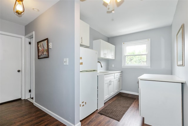 11 Glenwood Rd, Glen Head, NY 11545 - kitchen with freestanding refrigerator, dark wood-style floors, white cabinets, light countertops, and a ceiling fan