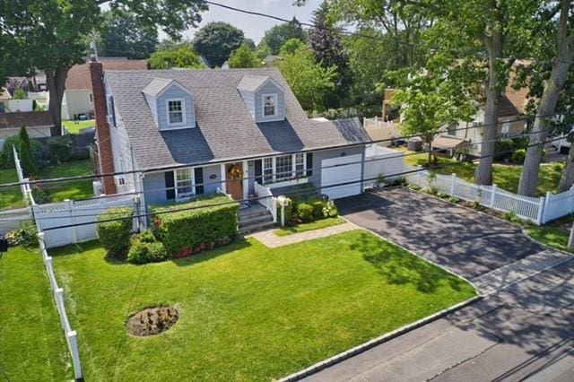 369 S 16th St, Lindenhurst, NY 11757 - cape cod house with asphalt driveway, a chimney, and an attached garage