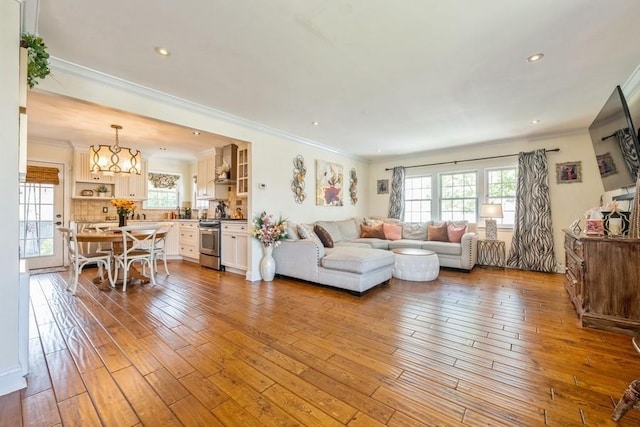 369 S 16th St, Lindenhurst, NY 11757 - living room with plenty of natural light, hardwood / wood-style flooring, crown molding, recessed lighting, and a chandelier