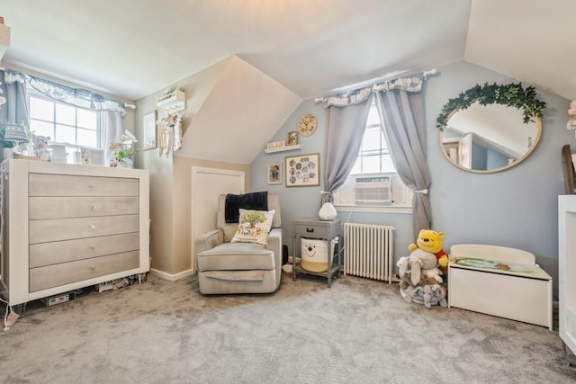 369 S 16th St, Lindenhurst, NY 11757 - living area featuring radiator, healthy amount of natural light, lofted ceiling, carpet floors, and cooling unit