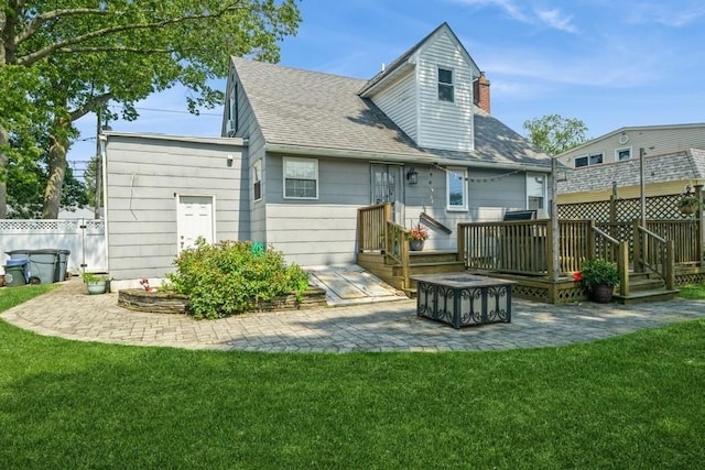 369 S 16th St, Lindenhurst, NY 11757 - back of property with a deck, a patio area, roof with shingles, a chimney, and an outdoor fire pit