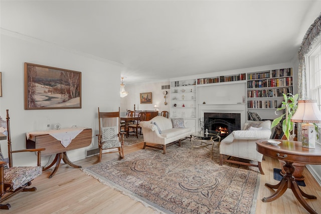 16 Ria Dr, White Plains, NY 10605 - living room featuring wood finished floors, a warm lit fireplace, and ornamental molding