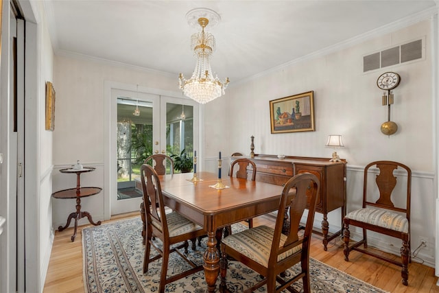 16 Ria Dr, White Plains, NY 10605 - dining room with light wood-style flooring, a chandelier, and ornamental molding