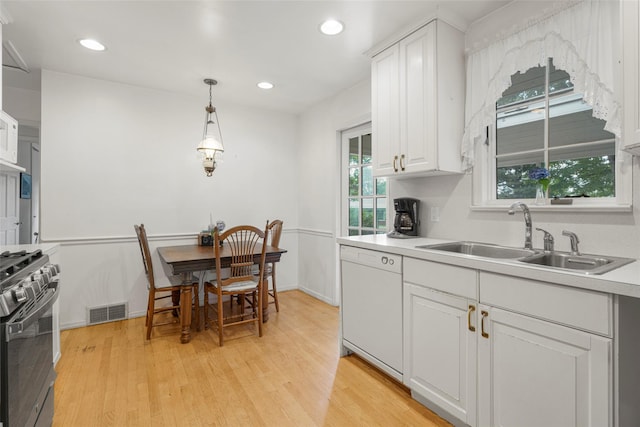16 Ria Dr, White Plains, NY 10605 - kitchen featuring white dishwasher, gas stove, light wood-style flooring, white cabinetry, and light countertops