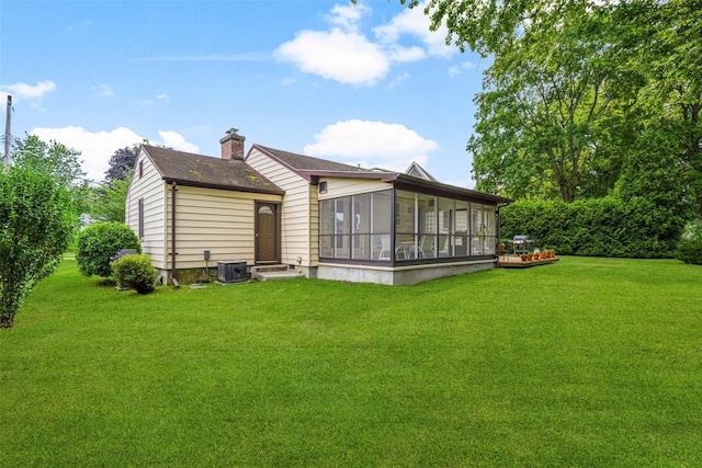 16 Ria Dr, White Plains, NY 10605 - back of house with a sunroom, a yard, a chimney, and roof with shingles