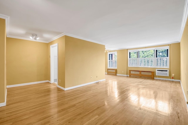 6 Birchwood Ct Unit 5N, Mineola, NY 11501 - empty room with ornamental molding, light wood-style flooring, and a wall mounted air conditioner