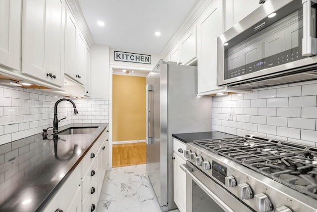 6 Birchwood Ct Unit 5N, Mineola, NY 11501 - kitchen featuring stainless steel appliances, light marble finish flooring, dark countertops, white cabinetry, and recessed lighting