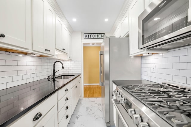 6 Birchwood Ct Unit 5N, Mineola, NY 11501 - kitchen with appliances with stainless steel finishes, light marble finish floors, backsplash, white cabinets, and recessed lighting
