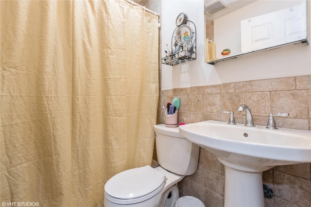 232 Broad St, Williston Park, NY 11596 - bathroom featuring tile walls, a shower with shower curtain, and a wainscoted wall