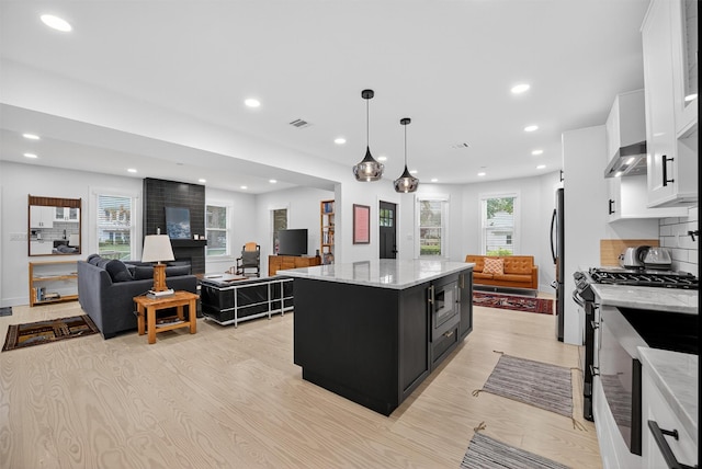 39 Frost Ln, Cornwall, NY 12518 - kitchen featuring dark cabinetry, stainless steel appliances, white cabinetry, a center island, and light wood finished floors