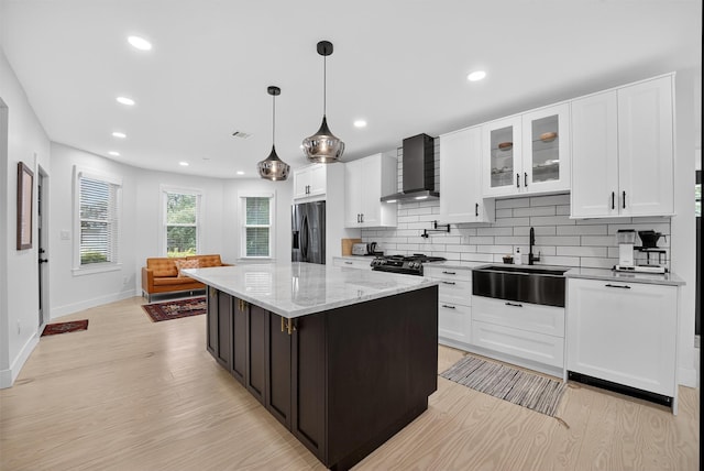 39 Frost Ln, Cornwall, NY 12518 - kitchen featuring wall chimney range hood, refrigerator with ice dispenser, light wood-type flooring, backsplash, and white cabinets