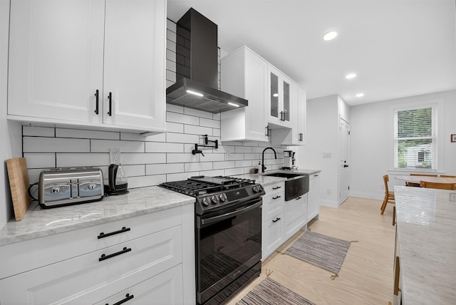 39 Frost Ln, Cornwall, NY 12518 - kitchen with range with gas stovetop, wall chimney range hood, white cabinets, tasteful backsplash, and recessed lighting