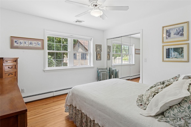 2055 Bay Shore Rd, Greenport, NY 11944 - bedroom with a baseboard radiator, wood finished floors, and ceiling fan