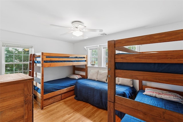 2055 Bay Shore Rd, Greenport, NY 11944 - bedroom featuring multiple windows, wood finished floors, and ceiling fan