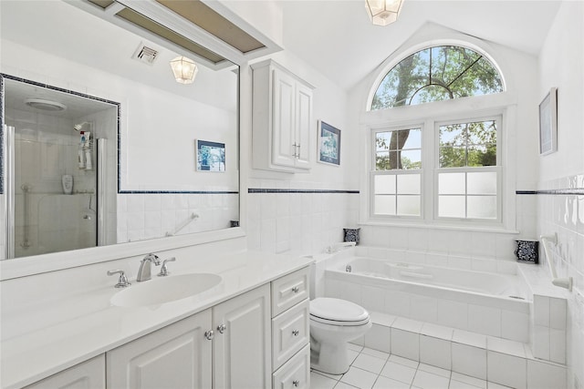 2055 Bay Shore Rd, Greenport, NY 11944 - full bathroom featuring tile patterned flooring, a bath, vanity, vaulted ceiling, and tile walls