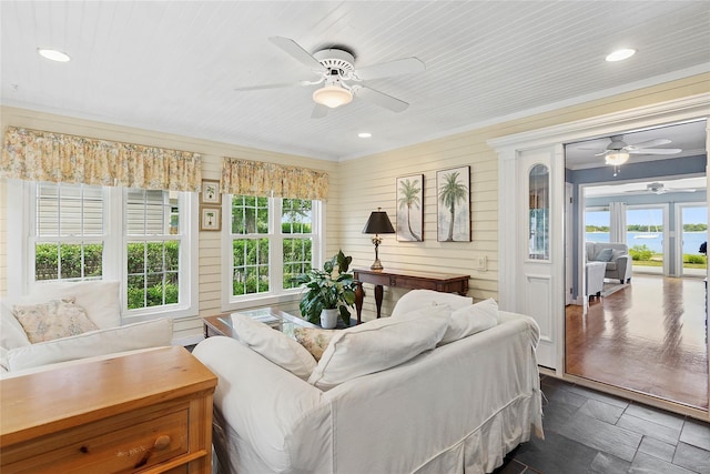 2055 Bay Shore Rd, Greenport, NY 11944 - living area featuring ceiling fan, recessed lighting, wood walls, wooden ceiling, and ornamental molding