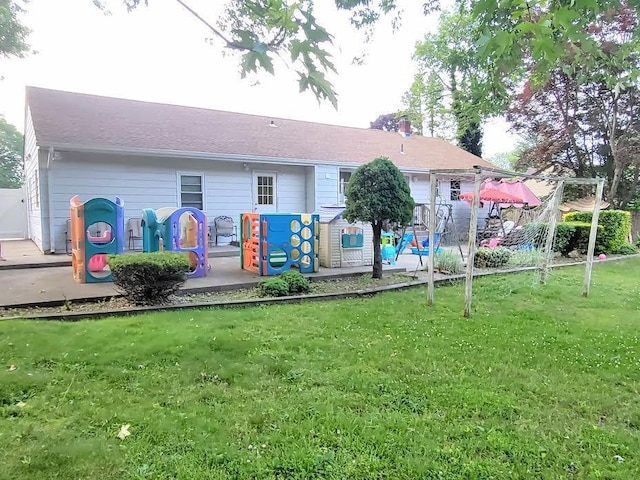22 Prospect Ave, Brentwood, NY 11717 - rear view of property with a chimney and a yard