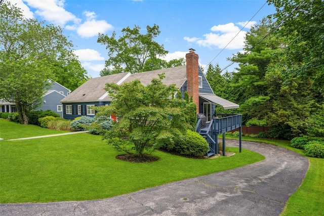 920 Protano Ln, Mamaroneck, NY 10543 - view of front of home featuring a chimney, a front lawn, a wooden deck, and stairway