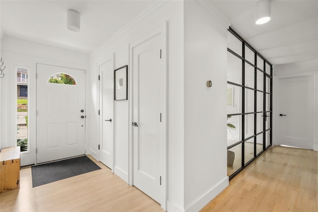 920 Protano Ln, Mamaroneck, NY 10543 - entryway with light wood-style floors and ornamental molding