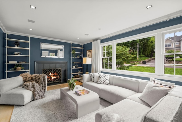 920 Protano Ln, Mamaroneck, NY 10543 - living area with crown molding, healthy amount of natural light, wood finished floors, a fireplace, and recessed lighting