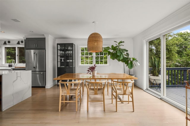920 Protano Ln, Mamaroneck, NY 10543 - dining area with light wood-style floors and ornamental molding