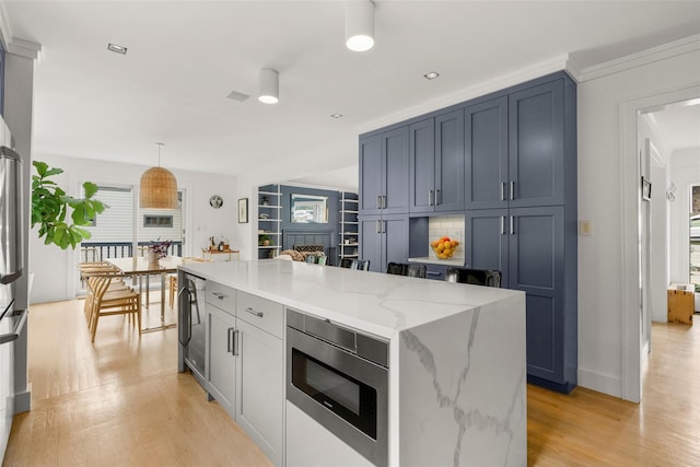 920 Protano Ln, Mamaroneck, NY 10543 - kitchen featuring stainless steel appliances, light wood-style floors, light stone counters, a kitchen island, and recessed lighting
