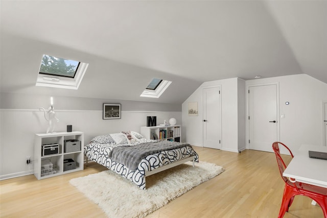 920 Protano Ln, Mamaroneck, NY 10543 - bedroom featuring a skylight, light wood-style flooring, and vaulted ceiling
