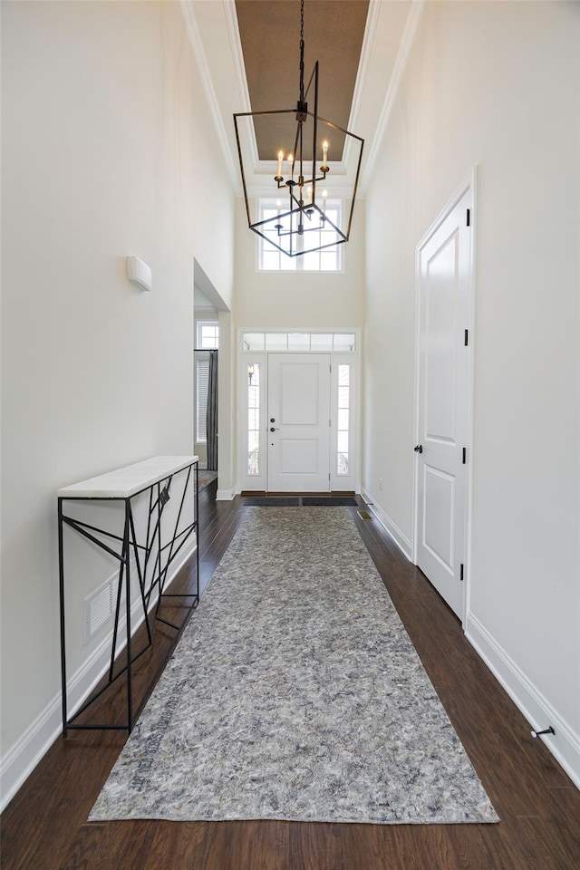 44 Linwood Dr, Wappingers Falls, NY 12590 - entrance foyer with ornamental molding, a chandelier, a high ceiling, and dark wood finished floors