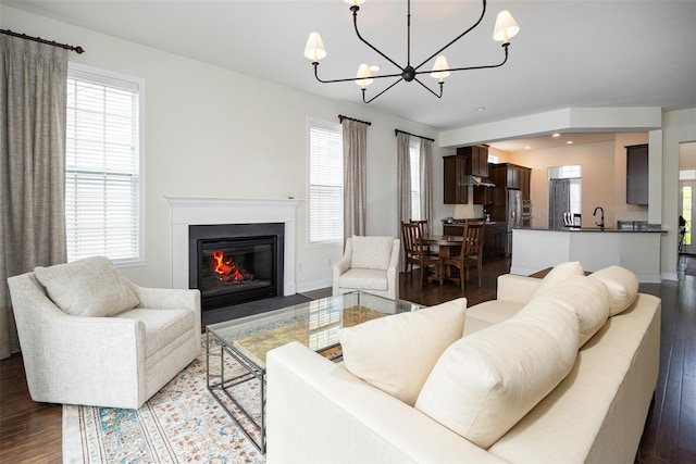44 Linwood Dr, Wappingers Falls, NY 12590 - living room featuring dark wood-style floors, a chandelier, a fireplace with flush hearth, and recessed lighting