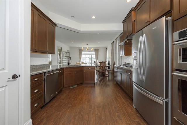 44 Linwood Dr, Wappingers Falls, NY 12590 - kitchen with appliances with stainless steel finishes, a peninsula, dark wood-style flooring, recessed lighting, and stone counters