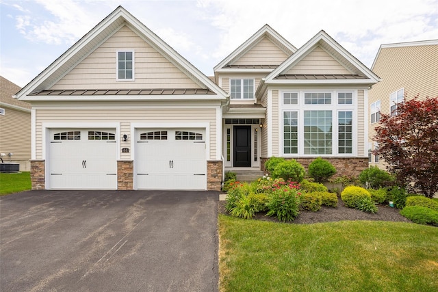 44 Linwood Dr, Wappingers Falls, NY 12590 - view of front of property featuring a standing seam roof, stone siding, asphalt driveway, a metal roof, and a front lawn