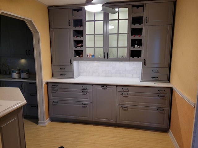 25 Herman Ave, North Babylon, NY 11703 - bar with light wood finished floors, backsplash, and ceiling fan