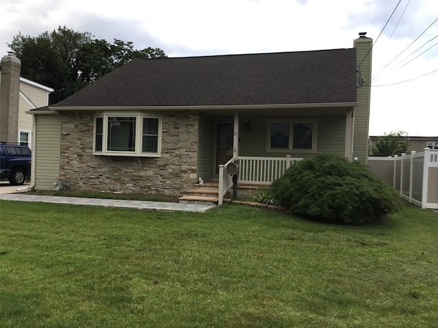 25 Herman Ave, North Babylon, NY 11703 - view of front of house featuring a chimney, covered porch, stone siding, and roof with shingles