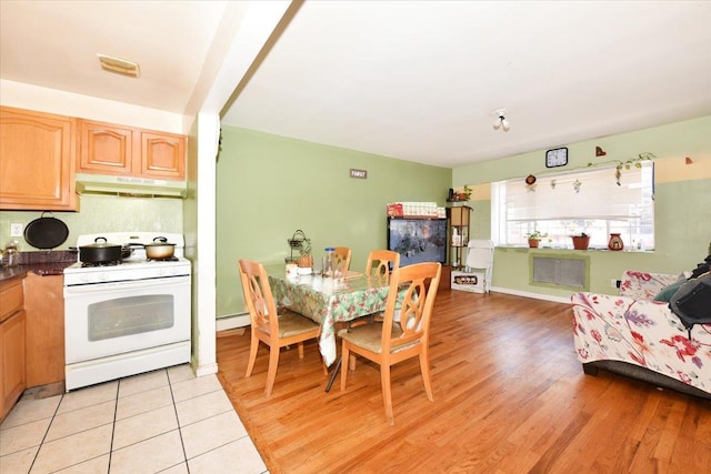35-44 104th St, Corona, NY 11368 - dining space with baseboard heating and light wood-style flooring