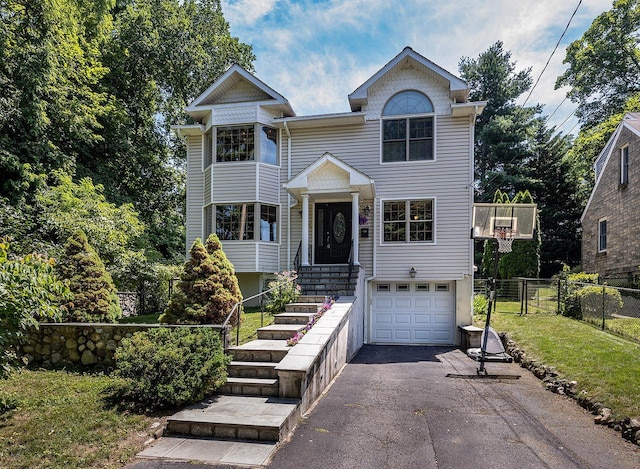 84 Macarthur Ln, Tarrytown, NY 10591 - view of front of house featuring a garage and asphalt driveway