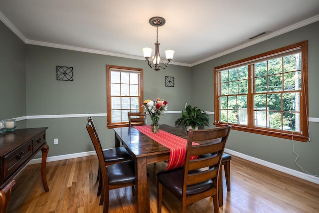84 Macarthur Ln, Tarrytown, NY 10591 - dining space with a chandelier, wood finished floors, and crown molding