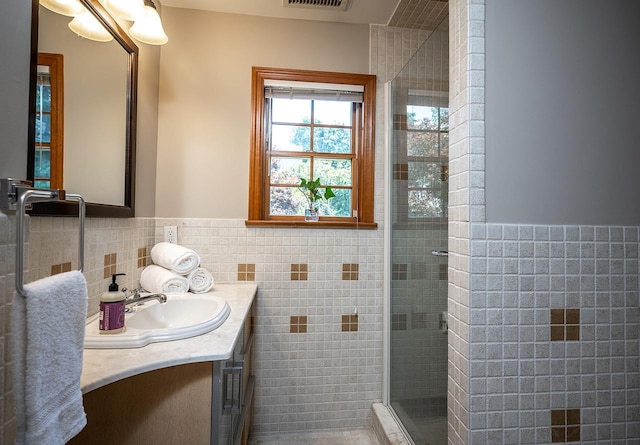 84 Macarthur Ln, Tarrytown, NY 10591 - bathroom with vanity, a shower stall, tile walls, and a wainscoted wall