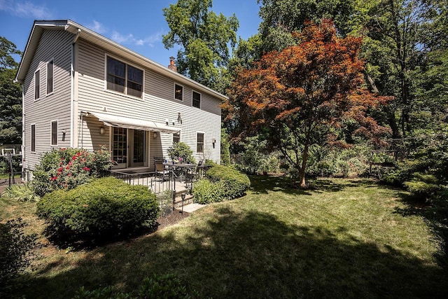 84 Macarthur Ln, Tarrytown, NY 10591 - back of property with a yard, a chimney, and a patio