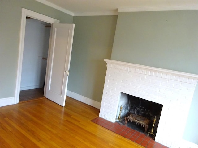 85 N Broadway Unit 2H, White Plains, NY 10603 - detailed view of wood finished floors, ornamental molding, and a brick fireplace